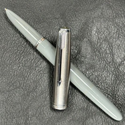 Dove Grey Parker 51, Vacumatic Filler Fountain Pen with 14K Fine Nib Name/Type: Parker 51 Manufacture Year: 1940s Length: 5 1/4 Filling System: Vacumatic Filler; restored Color/Pattern: Dove Grey with Lustraloy cap Nib Type/Condition and remarks: 14K Fine