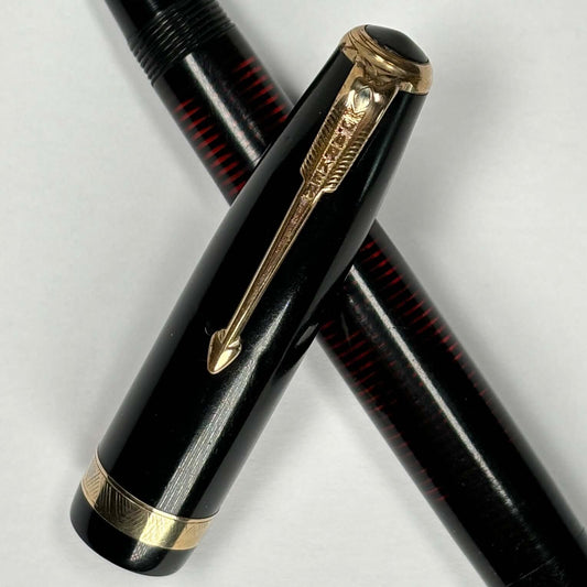 Black Parker Vacumatic Fountain Pen, Restored Vac-filler Name/Type: Parker Vacumatic Manufacture Year: 1930s Length: 5 1/4 Filling System: Restored Vacumatic with a speedline filler Color/Pattern: Black laminated with gold filled trim Nib Type/Condition a