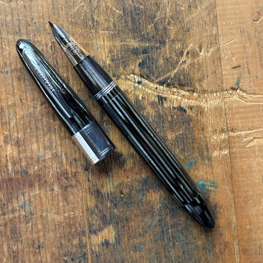 Sheaffer Triumph 1250 Lifetime Fountain Pen, Gray PearlName/Type: Sheaffer Triumph Length: 5 1/4 Filling System: Restored Vac-Fil with new seals Color/Pattern: Gray pearl barrel and cap with large chrome cap band Nib Type/Condition and remarks: Two-tone 1