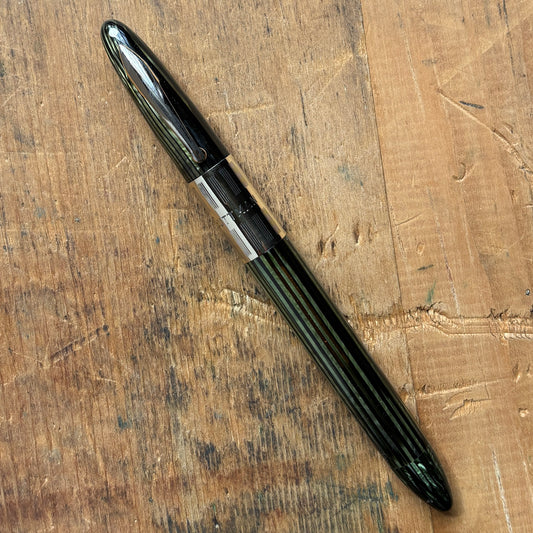 Sheaffer Triumph, Marine Green, Vac-fil, Extra-wide BandName/Type: Sheaffer Triumph Fountain Pen Manufacture Year: 1940s Length: 5 1/8 Filling System: Vacuum-Fil; restored with new seals Color/Pattern: Marine Green with gold-filled trim Nib Type/Condition