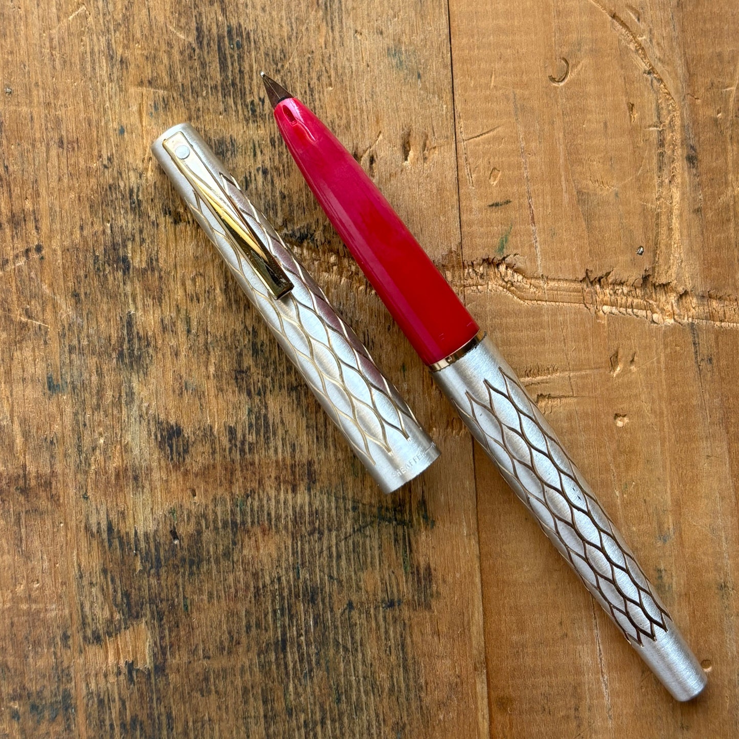 Lady Sheaffer 642-R, Satin TulleLength: 5 1/8 Filling System: Cartridge - Converter Color/Pattern: Satin Tulle with red section Nib Type/Condition and remarks: Fine 14k nib Condition: In excellent condition, still stickered and has no chips, cracks, or de