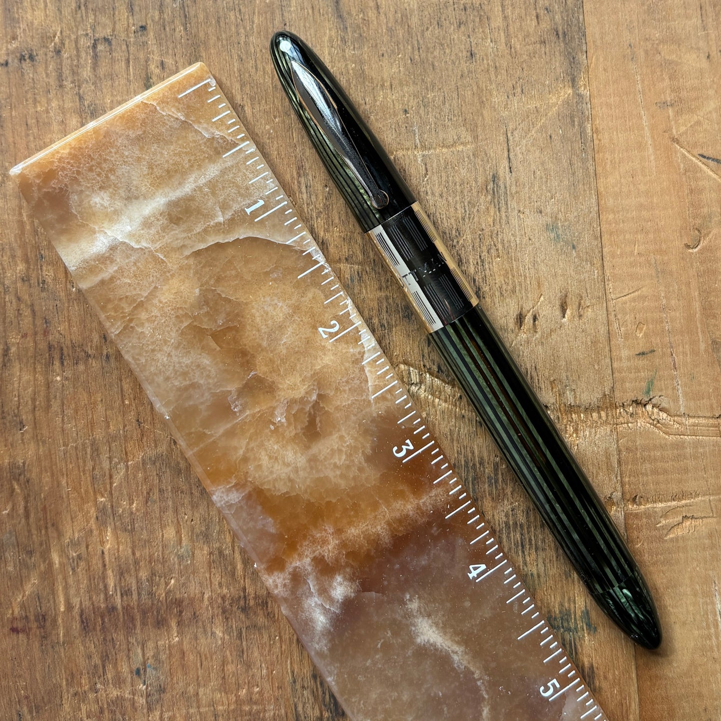 Sheaffer Triumph, Marine Green, Vac-fil, Extra-wide BandName/Type: Sheaffer Triumph Fountain Pen Manufacture Year: 1940s Length: 5 1/8 Filling System: Vacuum-Fil; restored with new seals Color/Pattern: Marine Green with gold-filled trim Nib Type/Condition