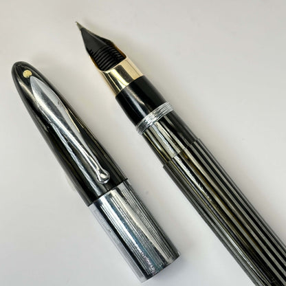 1940s Sheaffer Triumph Vac-fil, Extra-wide cap Band, Pearl Grey with Chrome trim. Medium Two-tone Nib Length: 5 1/8 Filling System: Vacuum-Fil; restored with new seals Color/Pattern: Pearl Grey with chrome trim Nib Type/Condition and remarks: Medium two-t