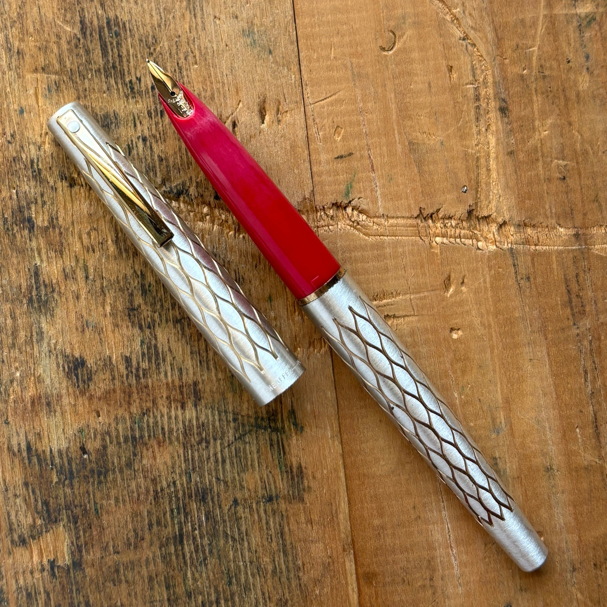 Lady Sheaffer 642-R, Satin TulleLength: 5 1/8 Filling System: Cartridge - Converter Color/Pattern: Satin Tulle with red section Nib Type/Condition and remarks: Fine 14k nib Condition: In excellent condition, still stickered and has no chips, cracks, or de