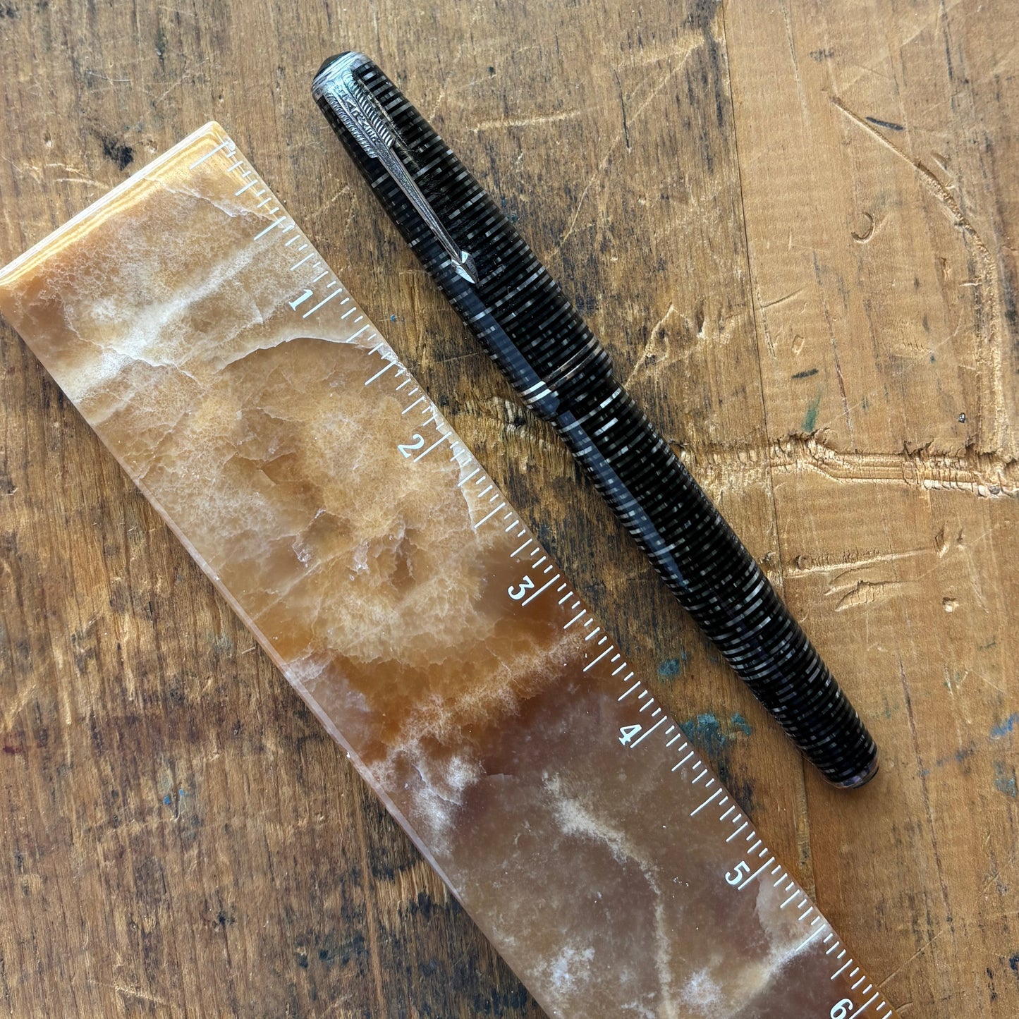 Double Jewel Parker Vacumatic; Silver PearlName/Type: Parker Vacumatic Manufacture Year: 1940 Length: 5 Filling System: Vacumatic with speed line filler Color/Pattern: Silver Pearl with Nickel Trim, two cap bands and double jeweled Nib Type/Condition and