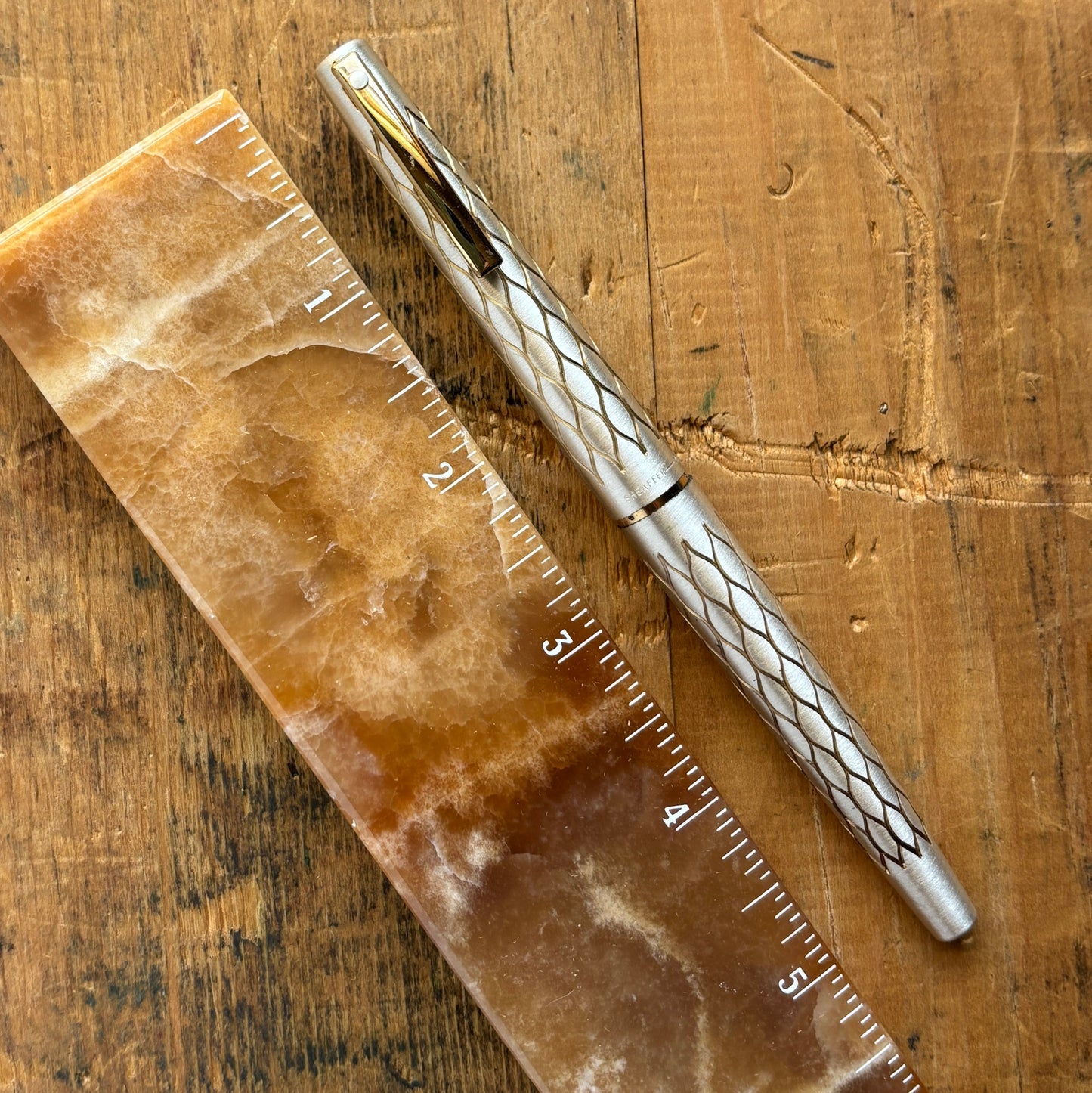 Lady Sheaffer 642-R, Satin TulleLength: 5 1/8 Filling System: Cartridge - Converter Color/Pattern: Satin Tulle with red section Nib Type/Condition and remarks: Fine 14k nib Condition: In excellent condition, still stickered and has no chips, cracks, or de