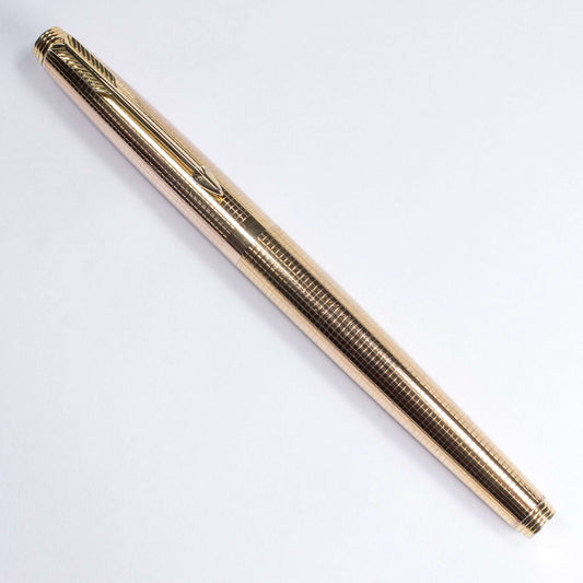 Gold Plated, Parker 75, Fine 14K Nib, C/C. Made in the U.S.A. Name/Type: Parker 75, Gold Plated Manufacture Year: 1970's Length: 5 1/8 Filling System: Parker Cartridges or Converter Color/Pattern: Gold-plated, engraved grid pattern. Nib Type/Condition and