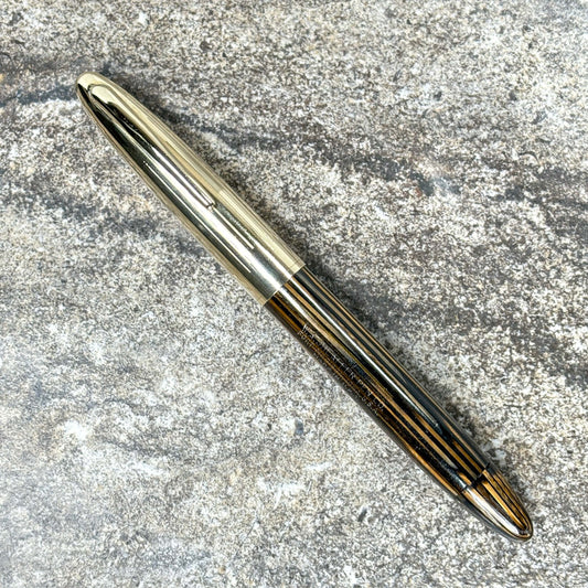 Sheaffer Crest Vac-fil with Triumph nib, and Gold filled cap Name/Type: Sheaffer Crest Manufacture Year: 1940s Length: 5 1/4 Filling System: Vacuum Filled, restored with new seals Color/Pattern: Golden Brown with 14K gold filled cap Nib Type/Condition and