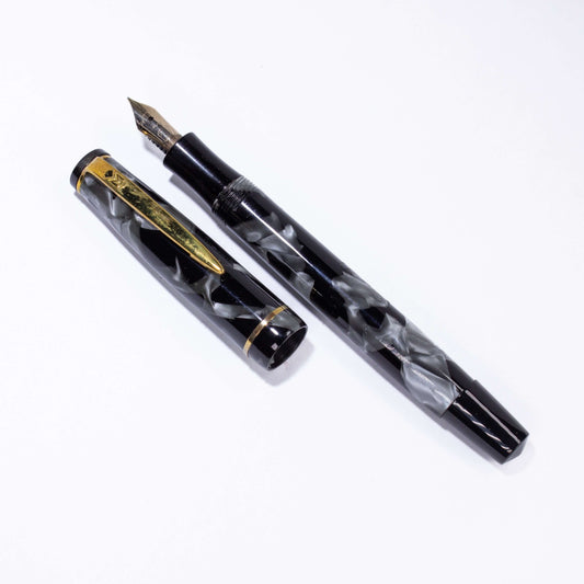Merlin 33 Fountain Pen, Black and Grey Pearl, Gold Trim 14K Merlin Nib, Flexible, Button Filler with New Sac Installed Type: Vintage Button Filler Fountain Pen Product Name: Merlin Manufacture Year: 1950s, made in Europe Length: 4 3/4 Filling System: Butt