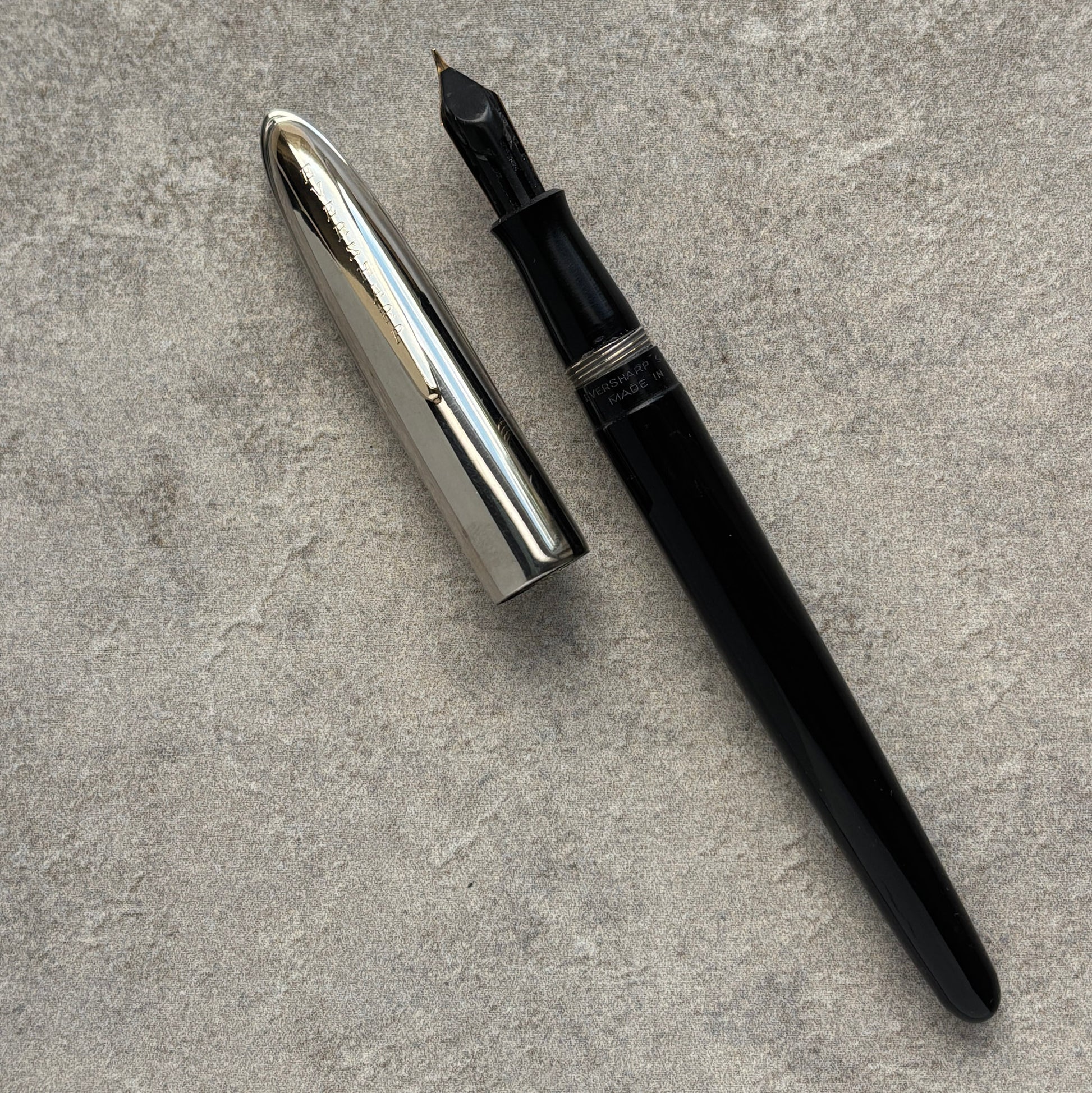 Black and silver fountain pen on a gray surface