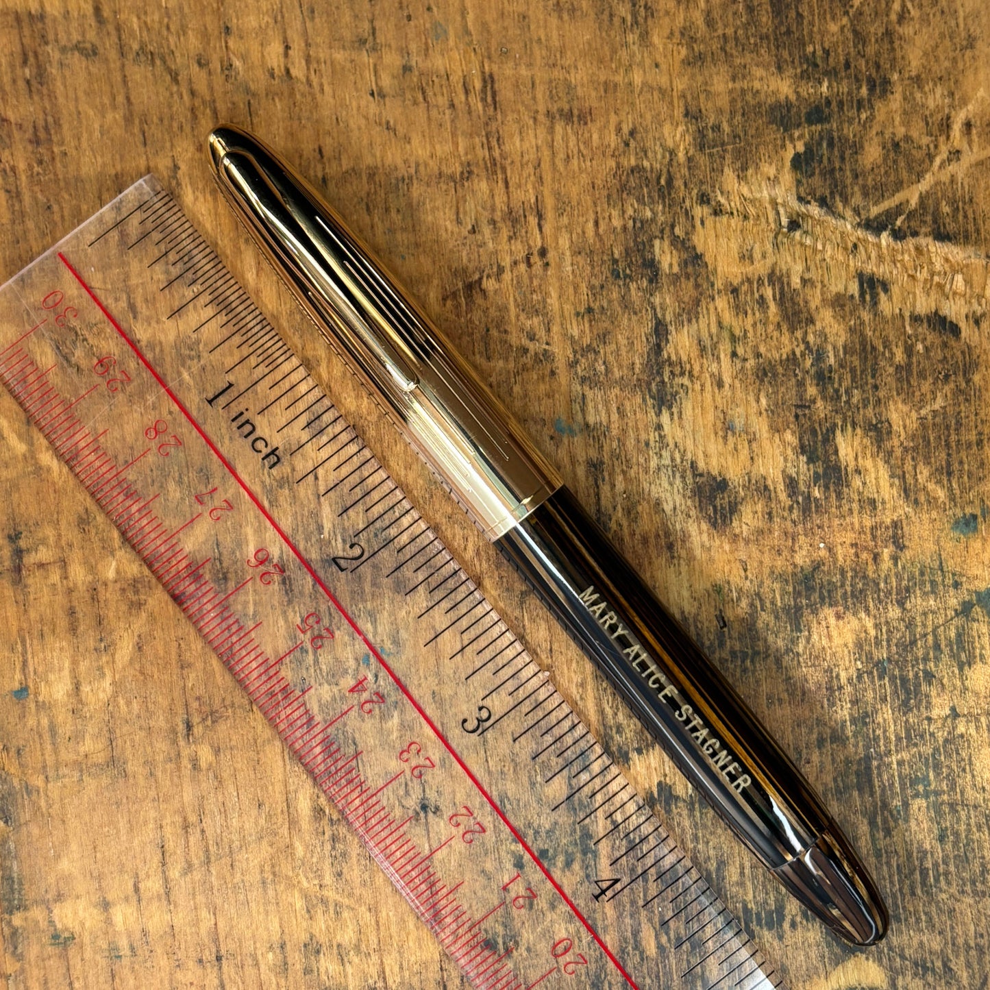 Sheaffer Crest, Golden BrownName/Type: Sheaffer Crest Manufacture Year: 1940s Length: 4 7/8 Filling System: Vac-fil, restored. Color/Pattern: Golden Brown Striated with gold-filled cap Nib Type/Condition and Remarks: Two-tone fine Triumph 14K nib, writes