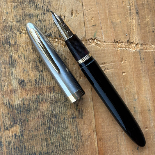 Sheaffer Sentinel Deluxe 1250 Restored Fountain PenName/Type: Sheaffer Sentinel Deluxe vac-fil Manufacture Year: 1947 Length: 5 1/4 Filling System: Restored Vac-fill with new seals. Color/Pattern: Black with a two-tone cap. Nib Type/Condition and remarks: