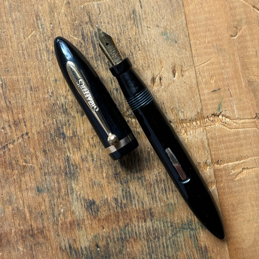 Sheaffer Petit Balance, Restored Lever-fillerName/Type: Sheaffer Petit Balance Manufacture Year: 1930s Length: 4 1/8 Filling System: Restored Lever Filler Color/Pattern: Black with gold-filled trim Nib Type/Condition and remarks: 14K medium nib marked She