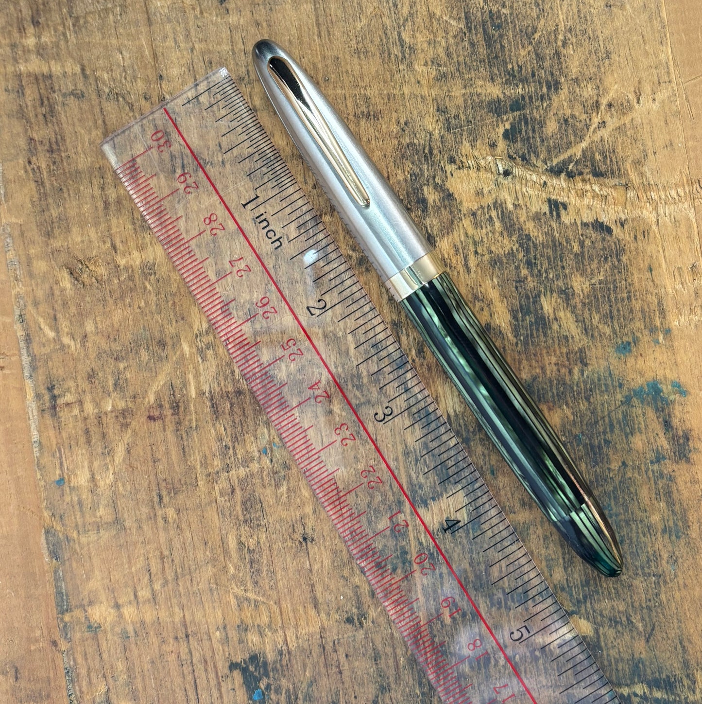 Sheaffer Sentinel Deluxe Restored Fountain PenName/Type: Sheaffer Sentinel Deluxe vac-fil Manufacture Year: 1947 Length: 5 Filling System: Restored Vac-fill with new seals. Color/Pattern: Marine Green with a two-tone cap. Nib Type/Condition and remarks: L