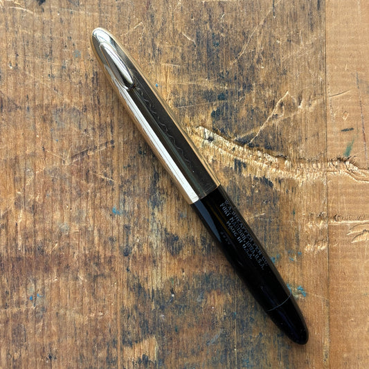 Sheaffer Tuckaway Crest, Black with Gold-Filled CapName/Type: Sheaffer Tuckaway Crest Manufacture Year: 1940s Length: 4 1/2 Filling System: Restored Vac-Fil Color/Pattern: Black with gold-filled cap Nib Type/Condition and remarks: Large two-tone 14K conic