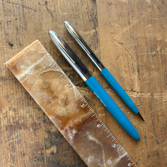 Sheaffer Sentinel Snorkel Fountain Pen/Pencil SetName/Type: Sheaffer Sentinel Manufacture Year: 1950s Length: 5 1/2 Filling System: Snorkel filler Color/Pattern: Hard to find color, Peacock Blue barrels with beautiful two-tone caps. Nib Type/Condition and