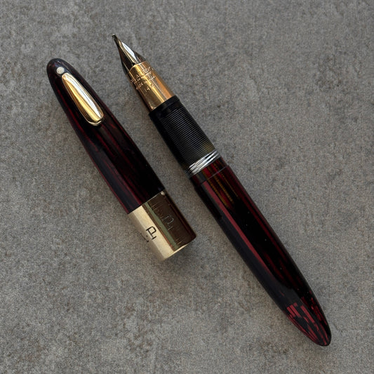 Fountain pen with gold accents on a gray surface