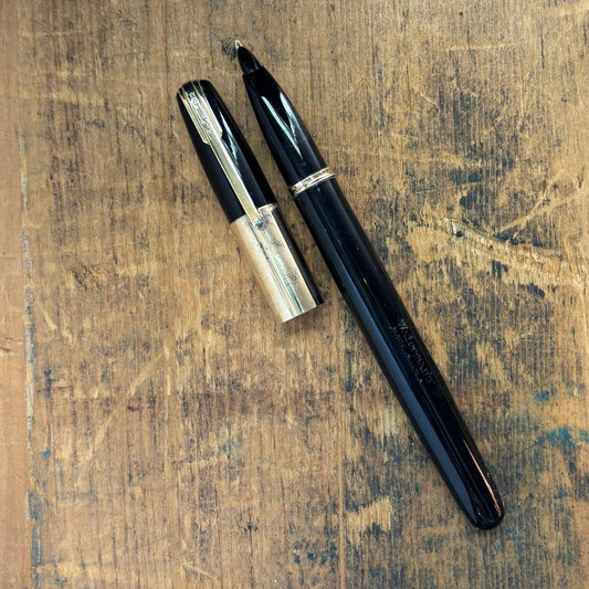 Waterman Taperite Citation, Black with Gold Filled TrimName/Type: Waterman Taperite Manufacture Year: 1940s Length: 5 1/4 Filling System: Lever Filler Color/Pattern: Black with Gold Filled Trim Nib Type/Condition and remarks: Medium 14K Nib; Fairly respon