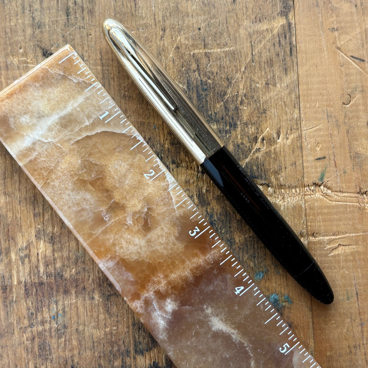 Sheaffer Triumph Crest Deluxe 1500 Fountain PenName/Type: Sheaffer Triumph Crest Deluxe Manufacture Year: 1940s Length: 5 1/4 Filling System: Vac-fil; restored with new sac Color/Pattern: Black barrel with gold-filled cap Nib Type/Condition and remarks: L