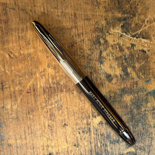 Sheaffer Crest, Golden BrownName/Type: Sheaffer Crest Manufacture Year: 1940s Length: 4 7/8 Filling System: Vac-fil, restored. Color/Pattern: Golden Brown Striated with gold-filled cap Nib Type/Condition and Remarks: Two-tone fine Triumph 14K nib, writes