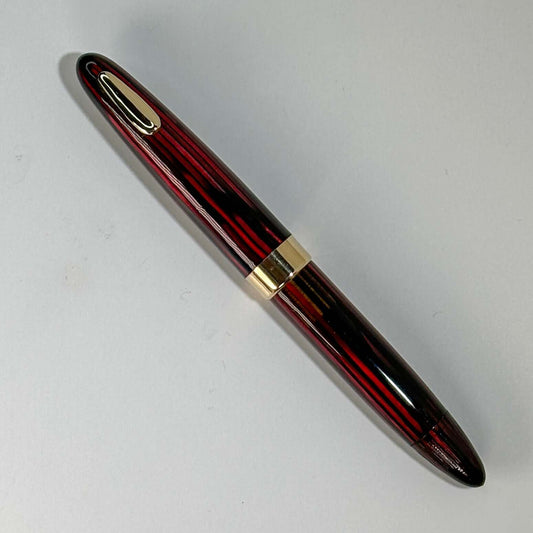 1940s Sheaffer Tuckaway Restored Vac-Fil, Carmine Red Name/Type: Sheaffer Tuckaway Manufacture Year: 1940s Length: 4 1/2 Filling System: Restored Vacuum fil Color/Pattern: Carmine Red with gold filled trim Nib Type/Condition and remarks: Fine two-tone nib