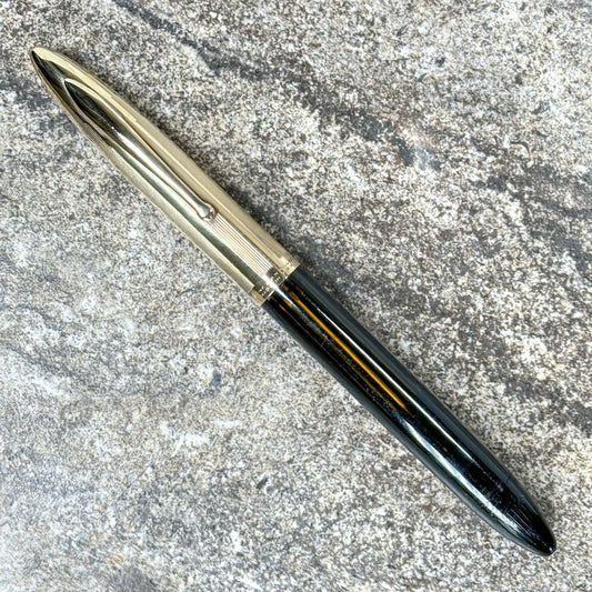 Sheaffer Crest with Triumph nib and Gold Filled Cap Name/Type: Sheaffer Crest Manufacture Year: 1940s Length: 5 3/8 Filling System: Restored Vac-fil Color/Pattern: Black barrel with excellent clarity, dent-free gold-filled cap. Nib Type/Condition and rema