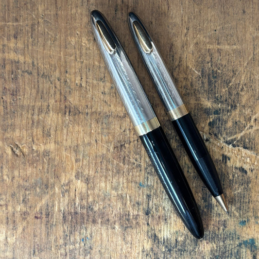 Sheaffer Tuckaway Sentinel Pen/Pencil Set, BlackName/Type: Sheaffer Tuckaway Manufacture Year: 1940s Length: 4 1/2 Filling System: Restored Vacuum fil Color/Pattern: Black with two-tone cap Nib Type/Condition and Remarks: Fine two-tone nib Condition: Exce