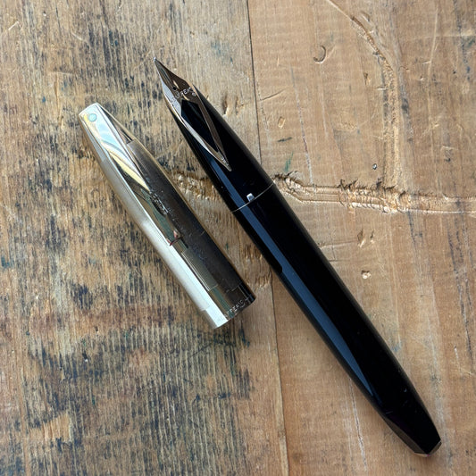 Sheaffer PFM V, Fully Restored in Black with Gold Filled CapName/Type: Sheaffer Pen For Men V Manufacture Year: 1959-1968 Length: 5 3/8 Filling System: Snorkel, restored with new sac and seals Color/Pattern: Black with gold-filled cap Nib Type/Condition a
