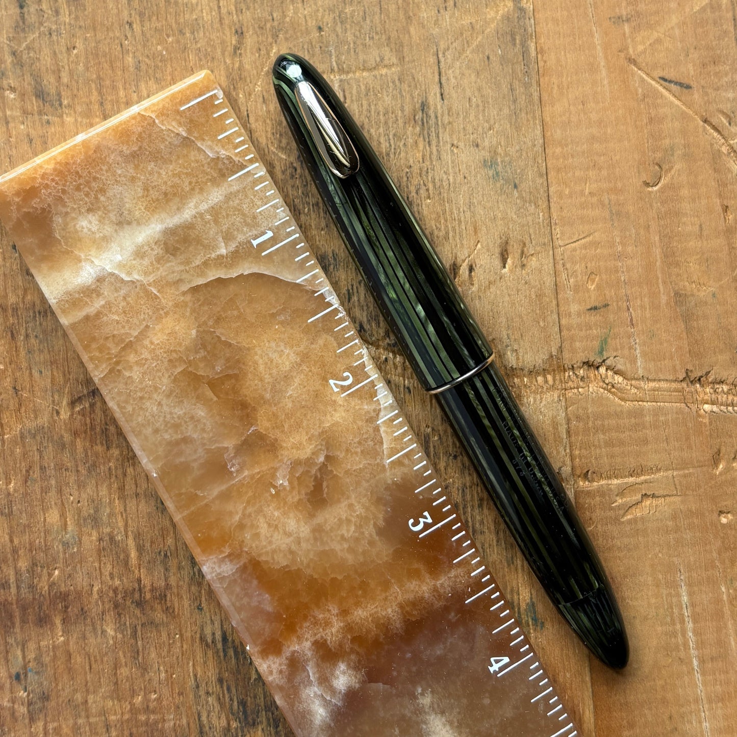 Sheaffer Tuckaway, Marine Green, Restored Vac-FilName/Type: Sheaffer Tuckaway Manufacture Year: 1940s Length: 4 3/8 Filling System: Vac-fil; fully restored Color/Pattern: Marine Green with gold-filled trim Nib Type/Condition and remarks: Large Triumph Lif