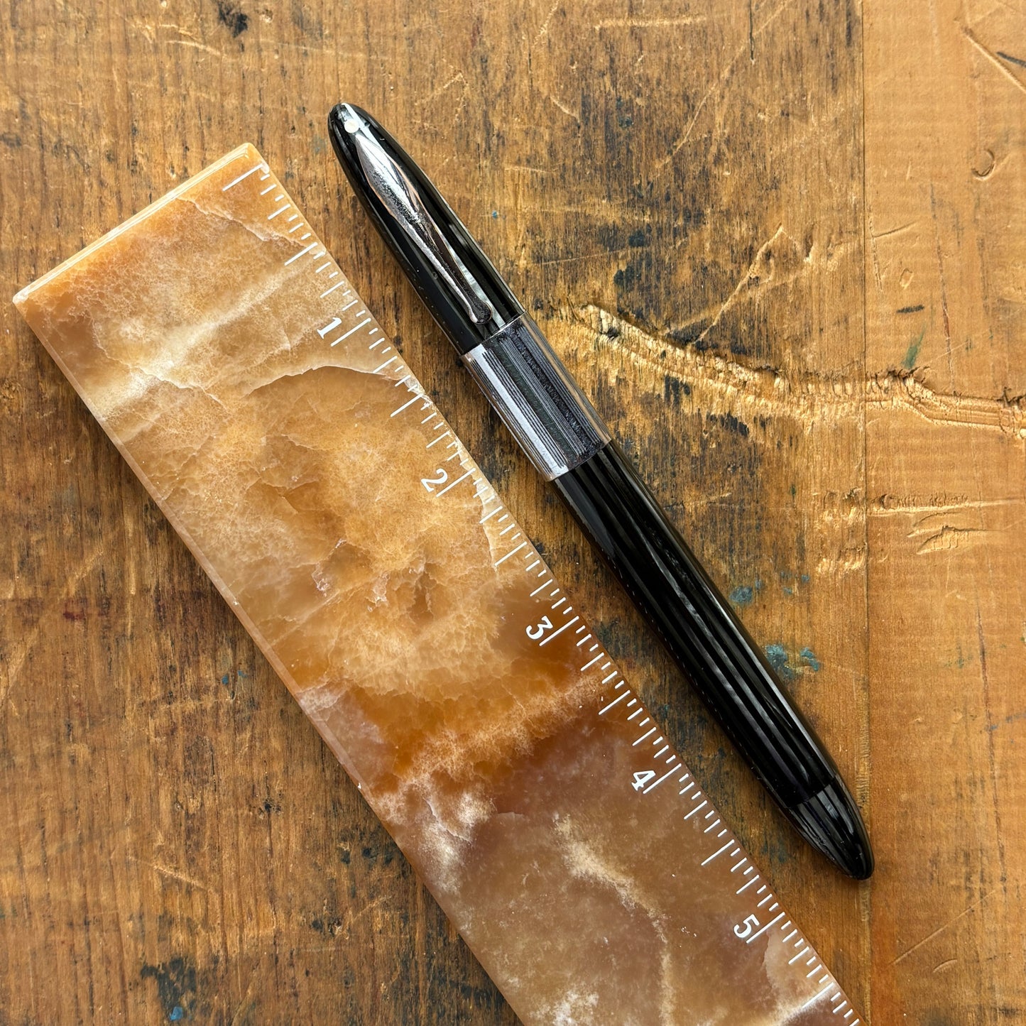 Sheaffer Triumph Vacuum-fil, Gray Pearl, Extra-wide cap BandLength: 5 1/8 Filling System: Vacuum-Fil; restored with new seals Color/Pattern: Gray pearl with gold-filled trim Nib Type/Condition and remarks: Medium two-tone 14K gold trim, smooth wet line. C