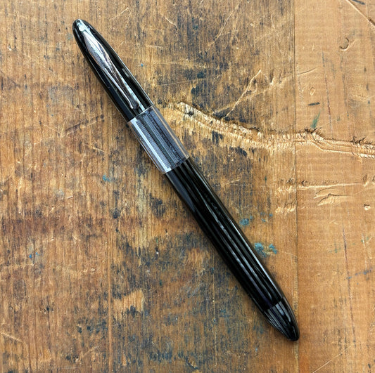 Sheaffer Triumph Vacuum-fil, Gray Pearl, Extra-wide cap BandLength: 5 1/8 Filling System: Vacuum-Fil; restored with new seals Color/Pattern: Gray pearl with gold-filled trim Nib Type/Condition and remarks: Medium two-tone 14K gold trim, smooth wet line. C