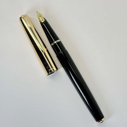 Pilot, Super 100, Flip Filler, Black with Gold Plated Cap Name/Type: Pilot Super 100 Manufacture Year: Early 1960s Length: 5 1/8 Filling System: Flip filler; restored with new sac Color/Pattern: Black with gold plated cap Nib Type/Condition and remarks: E