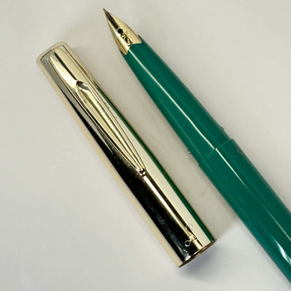 Sailor Fountain Pen; Green Barrel with Gold Cap Name/Type: Sailor Manufacture Year: Early 1960s Length: 5 1/4 Filling System: Aerometric Color/Pattern: Green barrel, Gold plated Cap Nib Type/Condition and remarks: Fine nib. Good condition