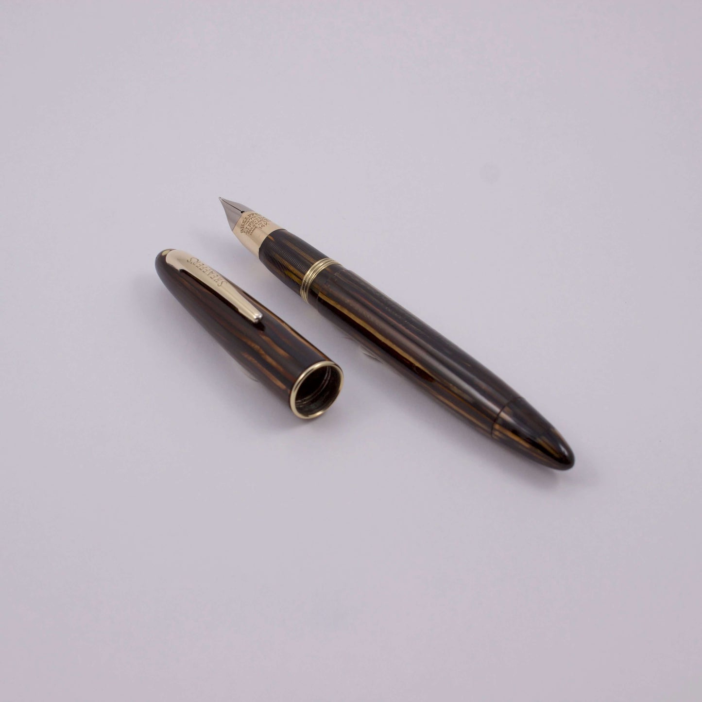 Sheaffer Vac-Fil, Brown Striated with a 14K Gold Two-tone Fine Nib, White Dot, Lifetime Product Name: Sheaffer Triumph Sovereign II Fountain Pen Manufacture Year: Mid 1940's Length: 4 7/8 Filling System: Vac-Fil, restored to working condition with new sea
