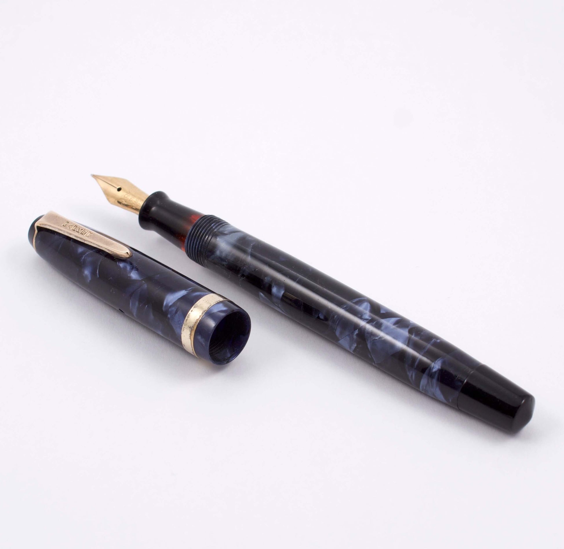 Parker Challenger, Blue Marble, Button Filler, Fine 14K Gold Nib, Restored Type: Parker Button Filler Fountain Pen Manufacture Year: 1940 Length: 4 3/4 small, petite Filling System: Button filler with new sac in working condition Color/Pattern: Blue Marbl