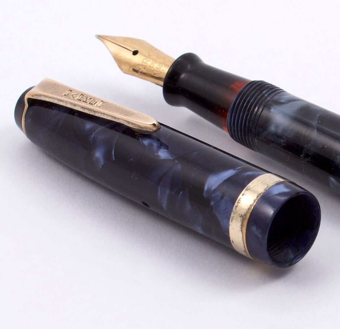 Parker Challenger, Blue Marble, Button Filler, Fine 14K Gold Nib, Restored Type: Parker Button Filler Fountain Pen Manufacture Year: 1940 Length: 4 3/4 small, petite Filling System: Button filler with new sac in working condition Color/Pattern: Blue Marbl