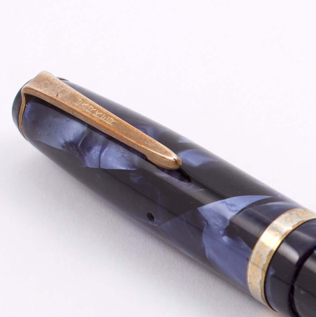 Parker Challenger, Blue Marble, Button Filler, Fine 14K Gold Nib, Restored Type: Parker Button Filler Fountain Pen Manufacture Year: 1940 Length: 5 1/4 Filling System: Button filler with new sac in working condition Color/Pattern: Blue Marble Nib Type/Con