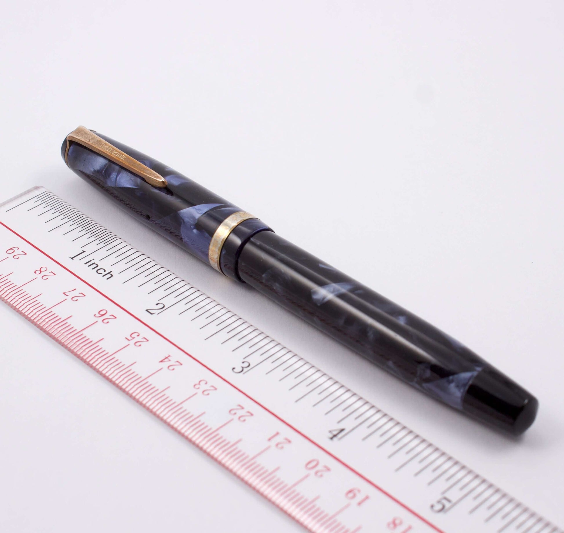 Parker Challenger, Blue Marble, Button Filler, Fine 14K Gold Nib, Restored Type: Parker Button Filler Fountain Pen Manufacture Year: 1940 Length: 5 1/4 Filling System: Button filler with new sac in working condition Color/Pattern: Blue Marble Nib Type/Con