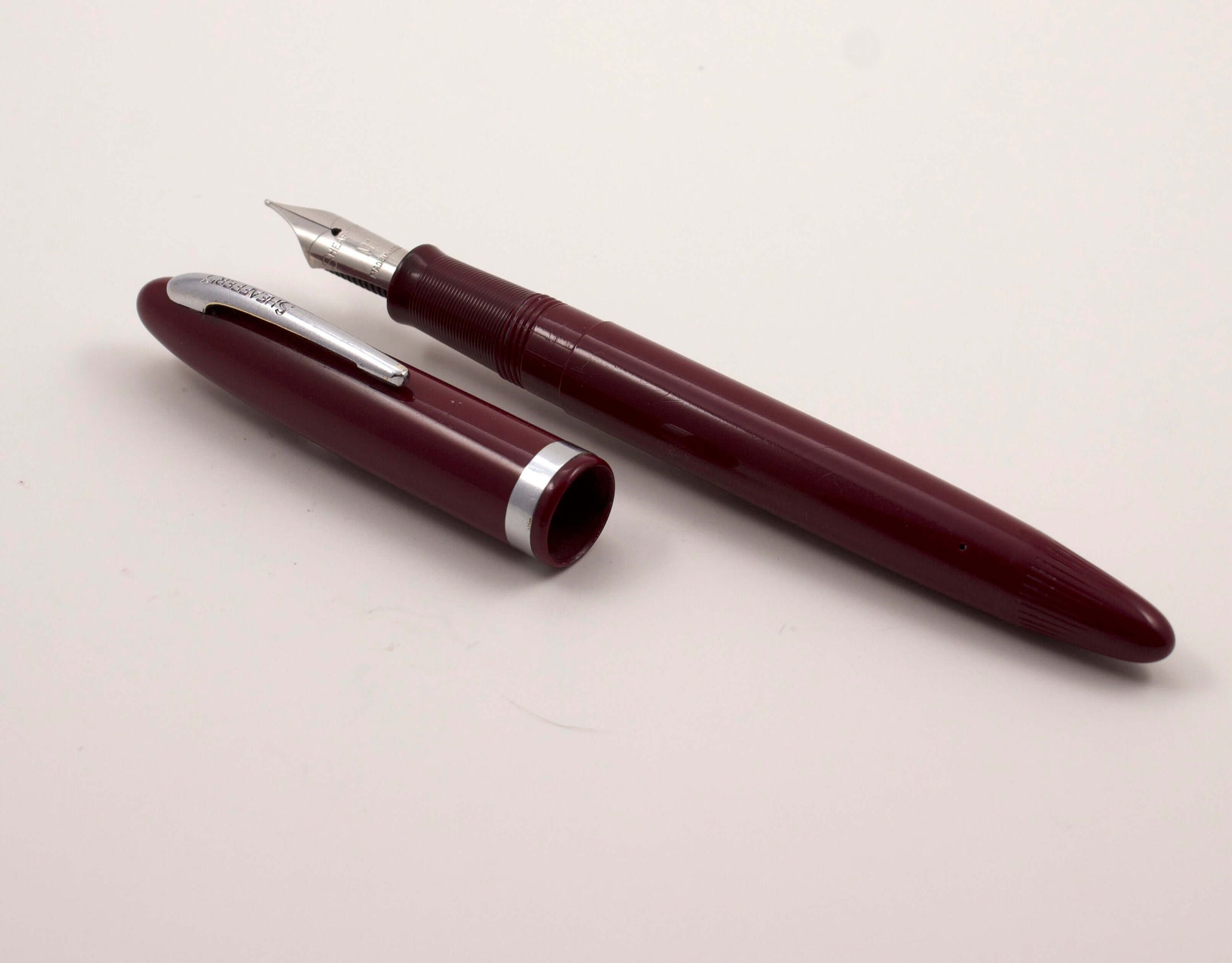 Sheaffer Tip-Dip Touchdown, Burgundy, 1950's Stainless Nib, M1 Medium Type: Sheaffer Tip Dip Fountain Pen Manufacture Year: 1950's Length: 5 1/8 Filling System: Touchdown; Restored with new sac and O-ring Color/Pattern: Burgundy Nib Type/Condition and rem