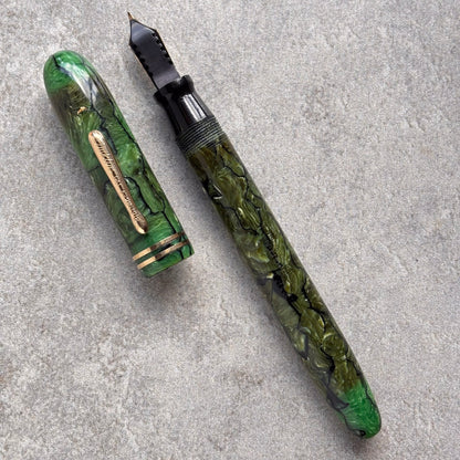 Green marbleized fountain pen on a gray surface