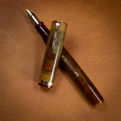 ${titleType: Waterman's Lady PatriciaManufacture Year: 1930'sLength: 4 5/16Filling System: Lever filler, restored with new sacColor/Pattern: Onyx, Cream with red veinsNib Type/Condition and remarks: Fine Accountant, Firm, Waterman's IdealCondition: Excell
