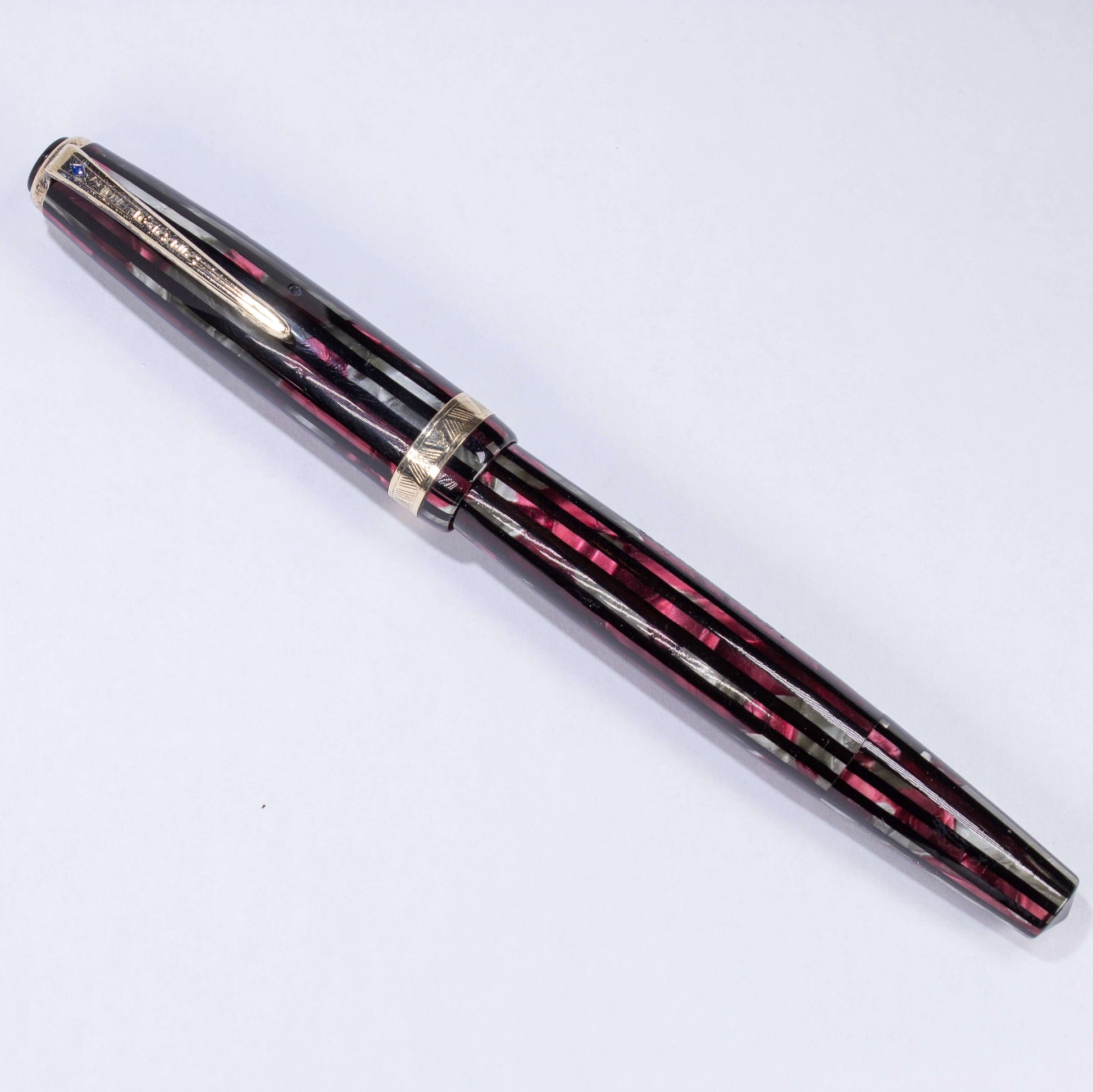Parker Striped Duofold- Duovac, 14K "V" Nib, Dusty Red, Restored Vintage Fountain PenName/Type: Parker Duovac Manufacture Year: 1945 Length: 5 1/4 Filling System: Restored Vacumatic with plastic filler Color/Pattern: Dusty Red Nib Type/Condition and remar