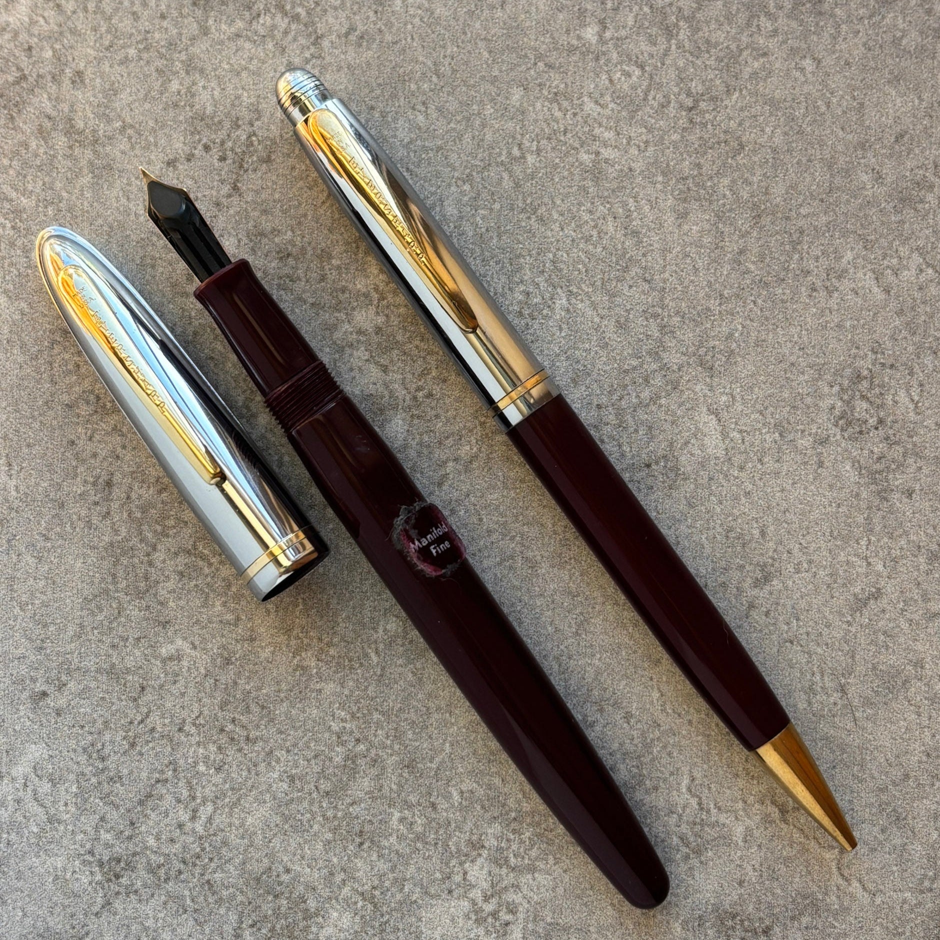 Fountain pen with and gold accents on a gray surface