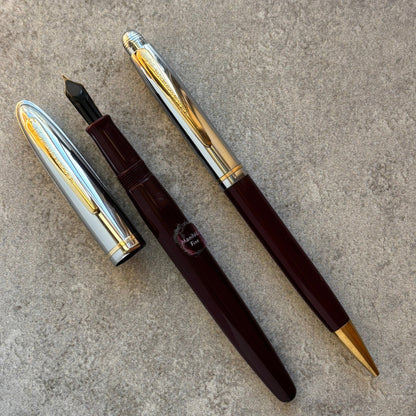 Fountain pen with and gold accents on a gray surface