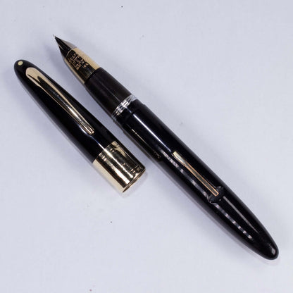 ${titleName/Type: Restored Vintage Fountain Pen Manufacture Year: 1940s Length: 5 1/4 Filling System: Lever filler with new sac Color/Pattern: Black Nib Type/Condition and remarks: Large Two-toned wraparound Triumph 14K fine nib Condition: ﻿This large She