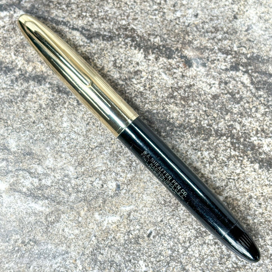 Sheaffer Crest Triumph, 14K Fine nib, Black with Gold Filled Cap Name/Type: Sheaffer Crest Triumph Manufacture Year: 1940s Length: 5 1/4 Filling System: Restored Vac-Fil Color/Pattern: Black with gold filled cap Nib Type/Condition and remarks: Fine, 14K T