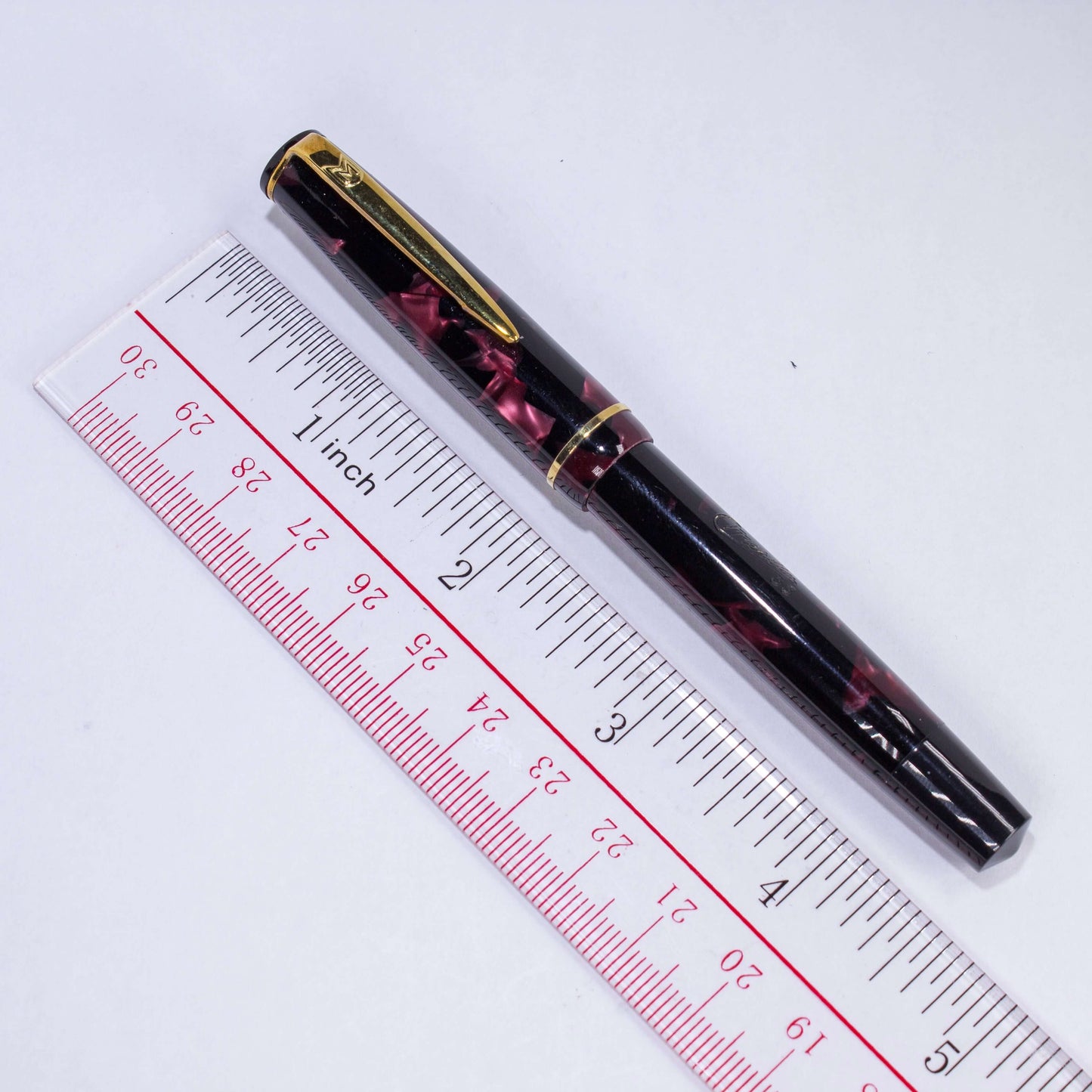 Merlin 33 Fountain Pen, Red Marble, Gold Trim 14K Merlin Nib, Flexible, Button Filler with New Sac Installed Type: Vintage Button Filler Fountain Pen Product Name: Merlin Manufacture Year: 1950s, made in Europe Length: 4 3/4 Filling System: Button Filler,