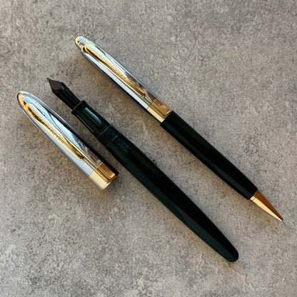 Two fountain pens,  on a textured surface.