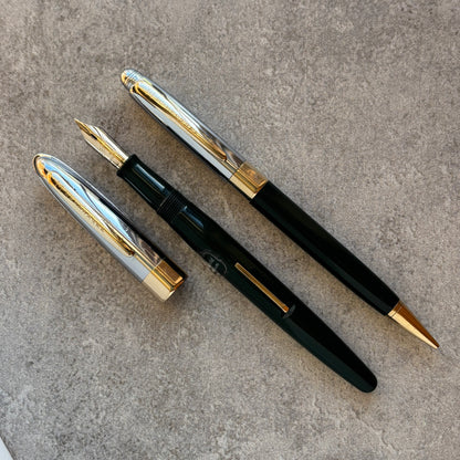 Two pens, on a textured surface.