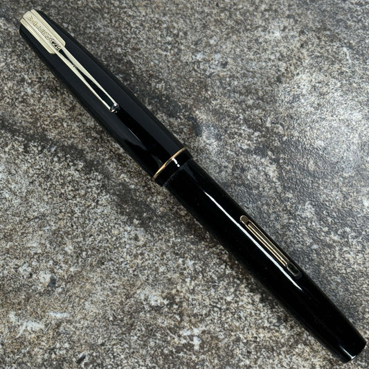 Waterman Starlet Fountain Pen, Black with a 14K nib Name/Type: Waterman Starlet Manufacture Year: 1940s Length: 4 7/8 Filling System: Lever Filler; restored. Color/Pattern: Black with gold-filled trim Nib Type/Condition and remarks: 14K Medium waterman Ni